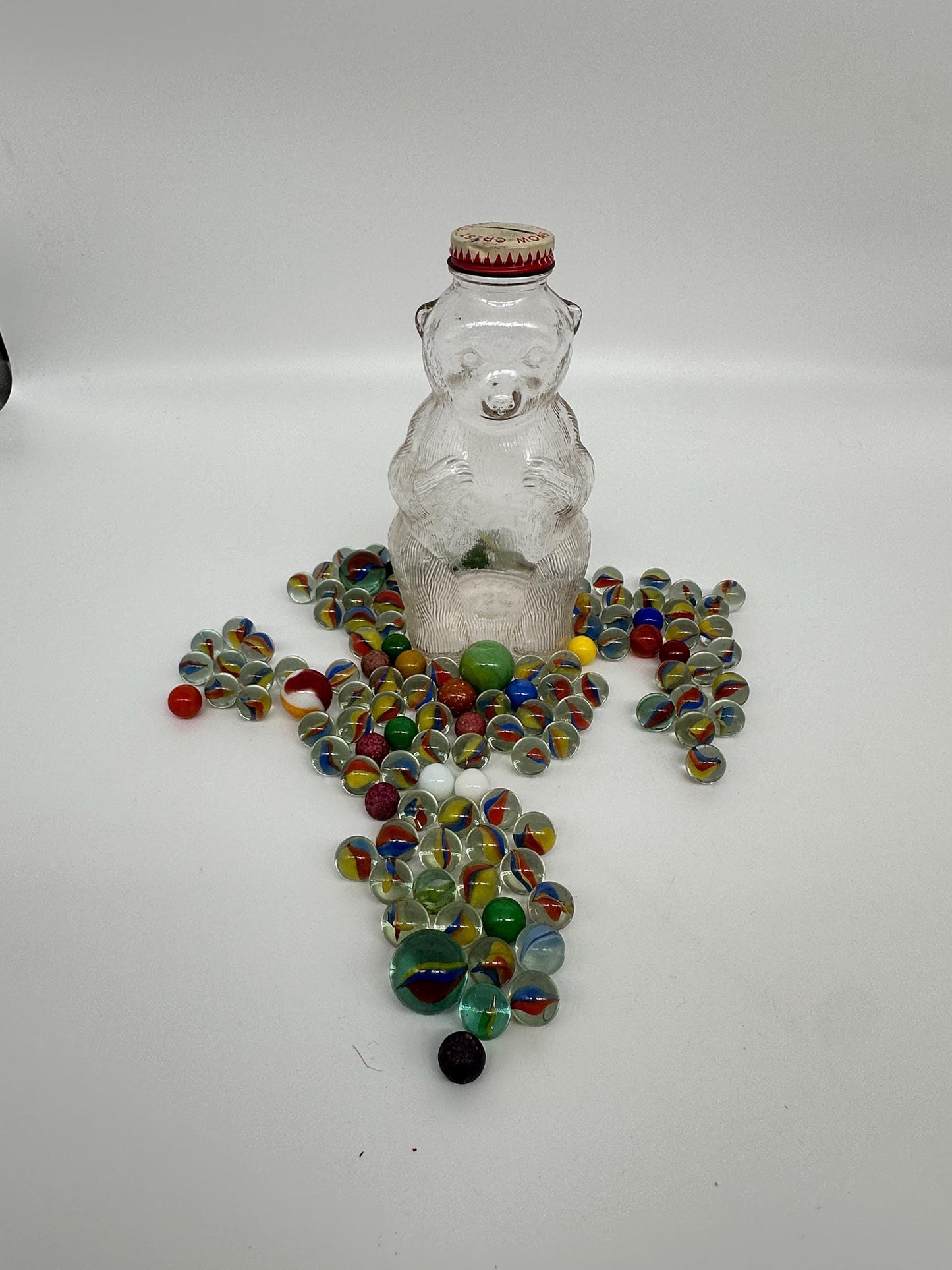 Vintage Snow Crest Glass Bear Bottle Bank with Marbles: Cat Eye Shooters