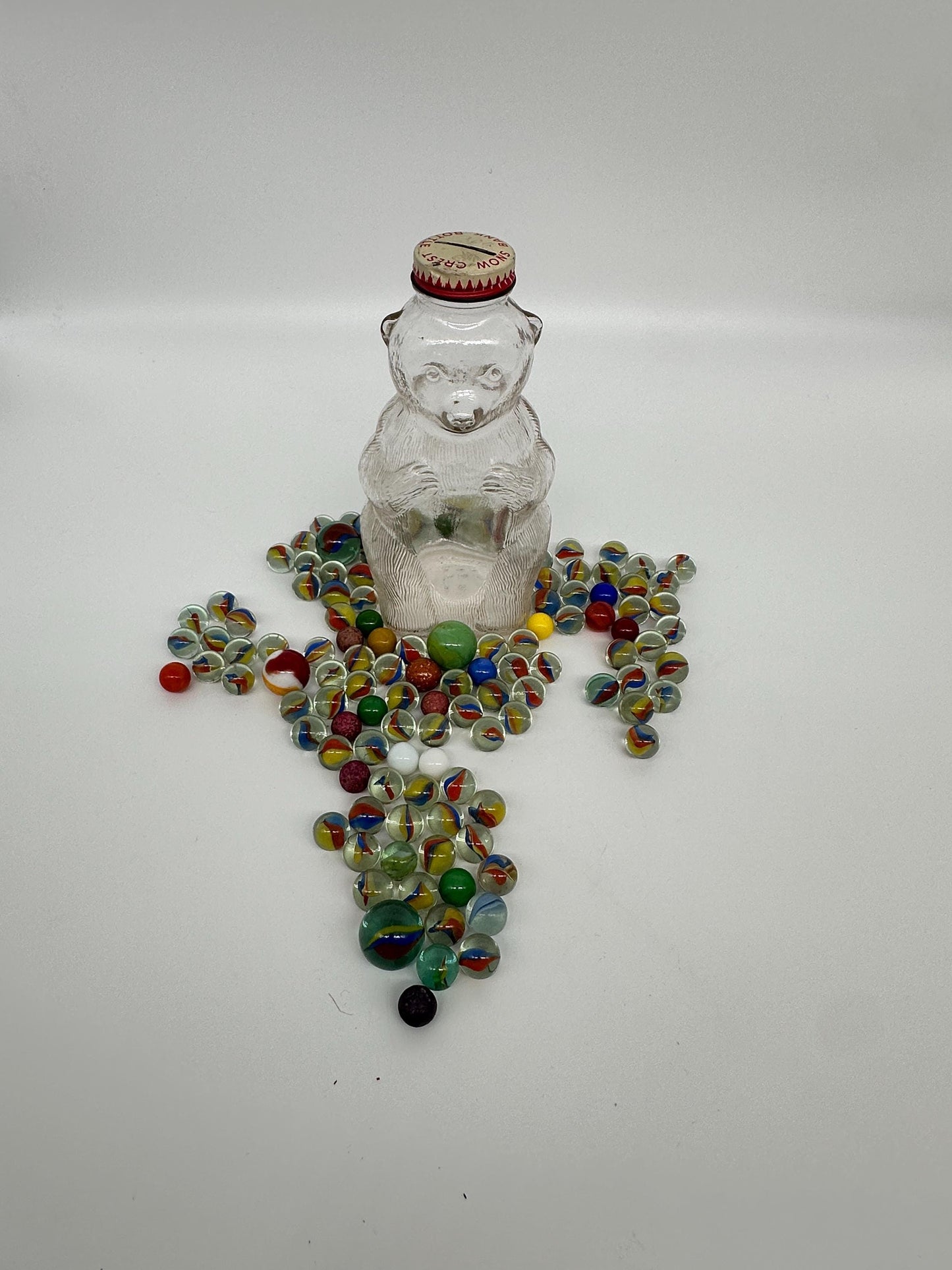 Vintage Snow Crest Glass Bear Bottle Bank with Marbles: Cat Eye Shooters