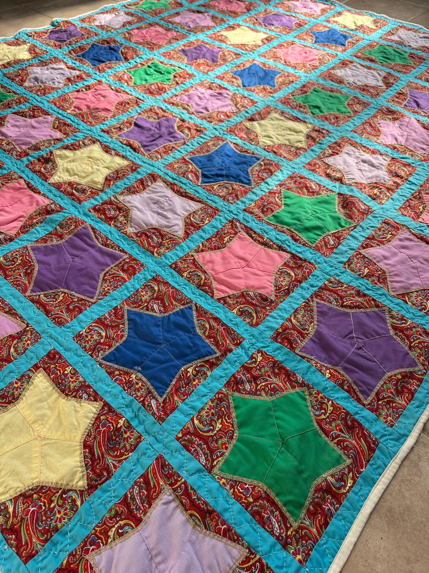 1980s Hand-Stitched Star Quilt – Multicolor Cotton, Paisley Background, Turquoise Border (67" x 77")