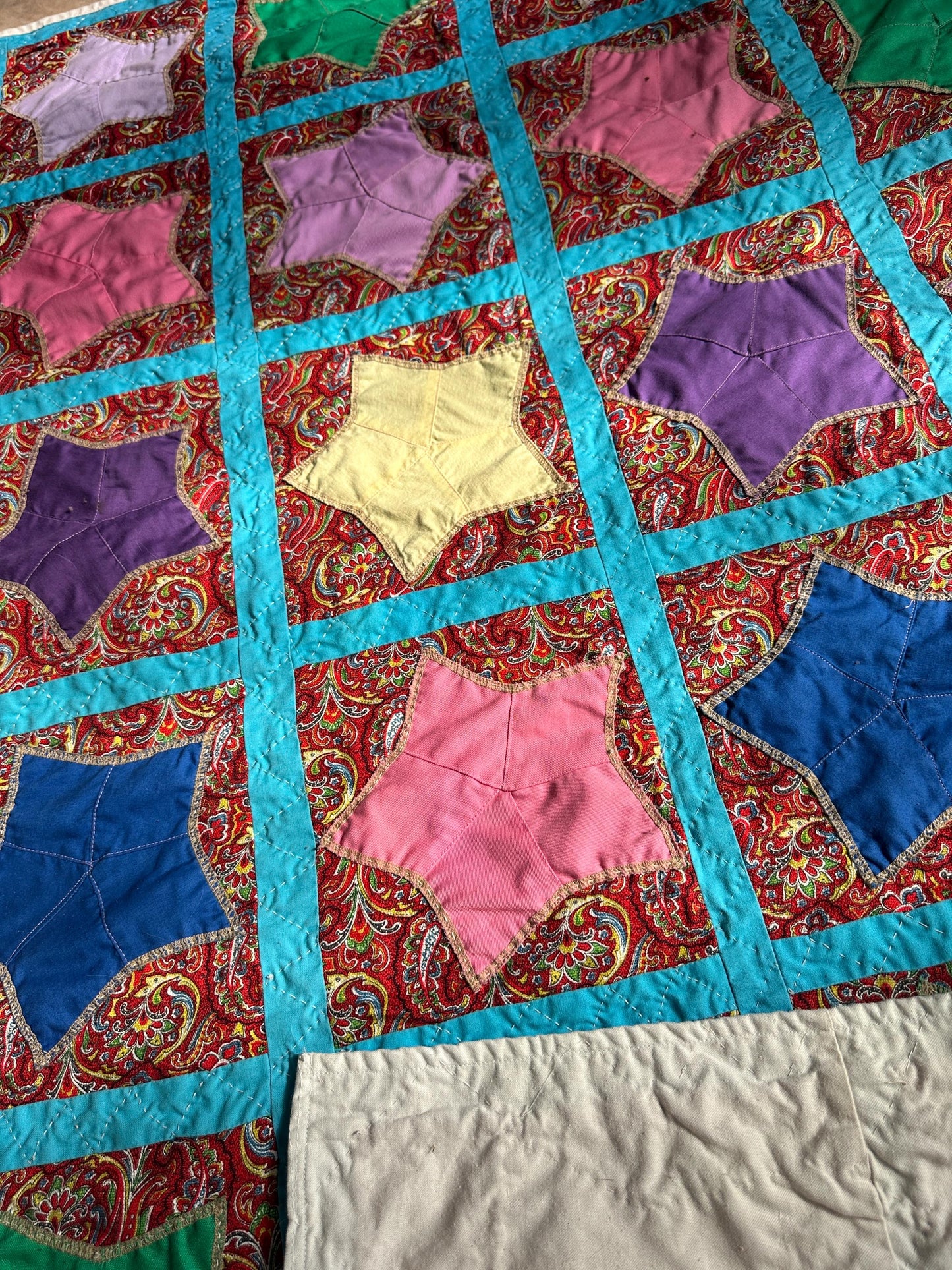 1980s Hand-Stitched Star Quilt – Multicolor Cotton, Paisley Background, Turquoise Border (67" x 77")