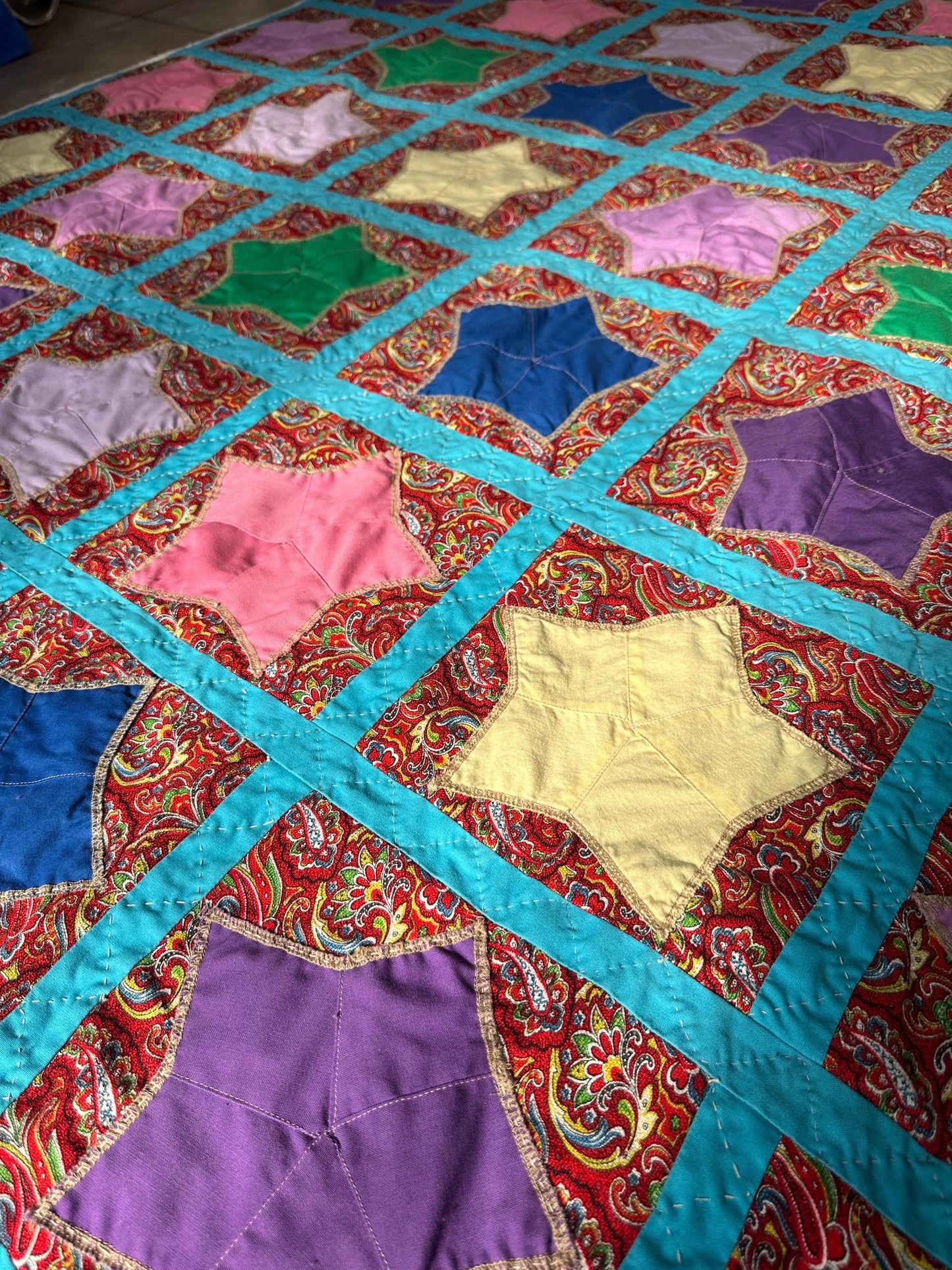 1980s Hand-Stitched Star Quilt – Multicolor Cotton, Paisley Background, Turquoise Border (67" x 77")